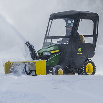 X590 Tractor shown with optional snow blower and weather enclosure